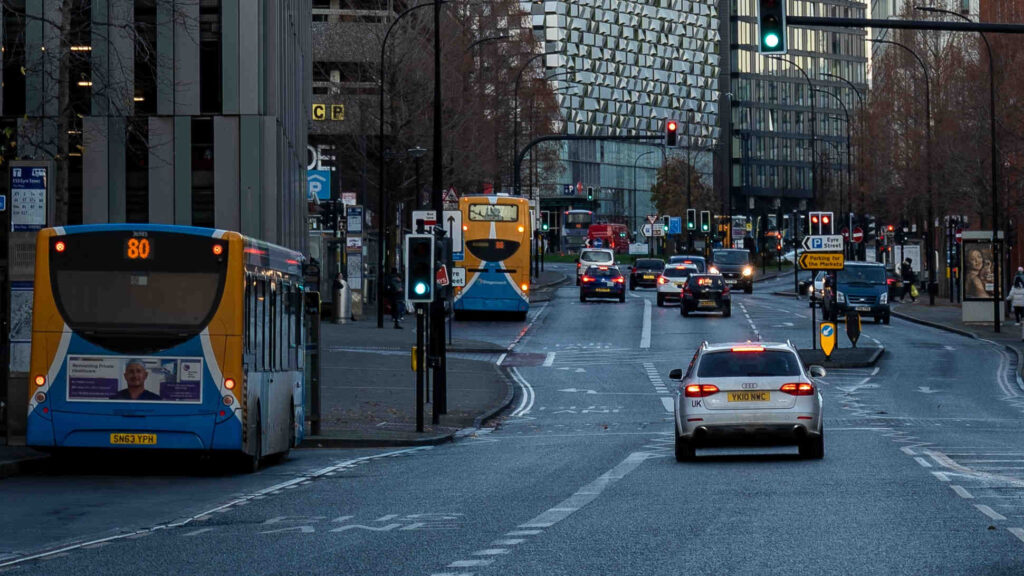 buses and cars on a city centre street